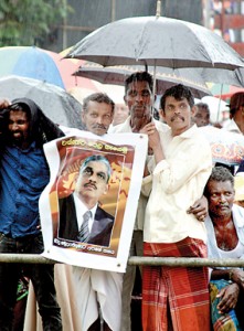 Above and below: Ardent  supporters  braving the rain