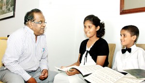 Mano chats with music students. Photo: Indika Handuwela