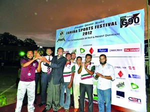 Winning team of the cricket tournament Palace Garden Team captain Salman Faris receiving the award from chief guest Uvaisul Karnain. Principal Mohamed Jiffry, Secretary BOG Rizvi Niyas, President G90 Riza Zarook and members are also in the picture. 