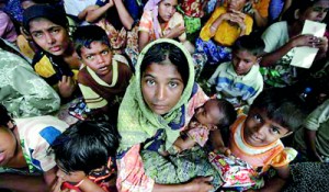 People displaced by the recent violence in the Kyukphyu township sit together after arriving to Thaechaung refugee camp, outside of Sittwe (REUTERS)