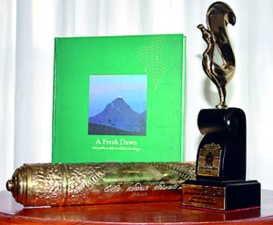 The winning cover design, the award and right, Somachandra (Ruwan) Peiris
