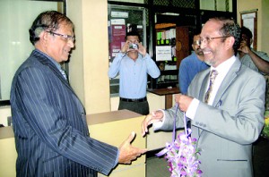 Author Harees (right) receiving chief guest and retired Chief Justice Asoka de Silva at the book launch at the auditorium of the Institute of Chartered Accountants.