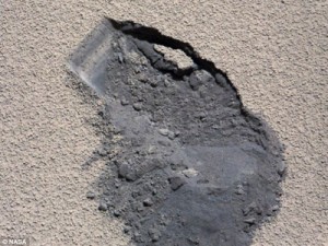 This image shows a 'bite mark' where NASA's Curiosity rover scooped up some Martian soil