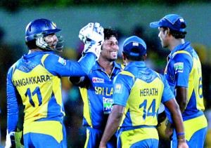 Jeewan Mendis, the man-of-the-match celebrates a wicket with his team mates.  - Pics by Shantha Ratnayake