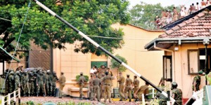 Commandos prepare for an assault while prison guards  try to talk prisoners down from the rooftop