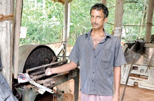 Nandana standing next to the machine that took his hand away.