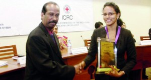 Dean of the Faculty of Law, University of Colombo, Mr V.T. Thamilmaran congratulates Lead Counsel of APIIT Law School team, Dilhara Gunaratne. — at Senate Room, College House, University of Colombo.