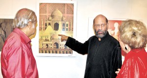An exhibition by internationally acclaimed Pakistani artist Jimmy Engineer is on at the Harrold Pieris Gallery  from 9 a.m. to 8 p.m. until November 22. Here the artist is seen explaining one of his paintings to an art lover. (Please see Plus Page 4 for an interview with the artist).