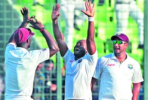 West Indies cricketer Tino Best (L) and teammate Veerasammy Permaul celebrate after winning the first cricket Test match between Bangladesh in Dhaka. - AFP