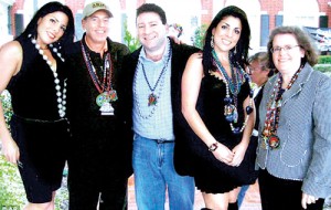 Rubbing shoulders: Jill Kelley (second right) and her twin sister Natalie (left) are pictured with David Petraeus, his wife Holly and Kelley's husband Scott (centre) at a party at their Tampa home