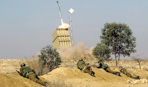 Operation: Israeli soldiers take cover as the 'Iron Dome' fires a missile (Daily Mail)