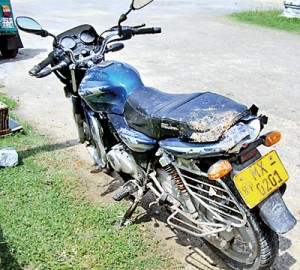 The motorcycle on which the ill-fated  father of four travelled on that fateful day and below his shoe on the riverbed.