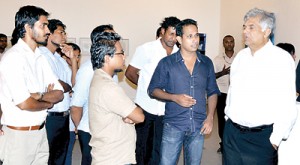 The Lionel Wendt Memorial Fund is hosting an exhibition, ‘Art and Sculpture’ which brings together a collection of modern art and sculpture of six young artists. Here opposition Leader Ranil Wickremesinghe is seen admiring one of the works of art and chatting with the artists. The exhibition is on till Nov. 20.  Pic by Ranjith Perera.   (Please see Plus Page 4  for story on  the art exhibition)