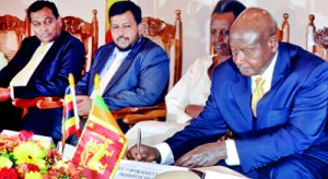 President of Uganda signs MoU document. Pic by Hasitha Kulasekera