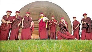 TThe 12th Gyalwang Drukp, left, poses with kung fu trained nuns accompanying him atCERN in Meyrin, near Geneva (REUTERS)