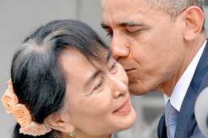 Obama kisses Myanmar opposition leader Aung San Suu Kyi after speaking to the press following their meeting at her residence in Yangon on November 19. AFP