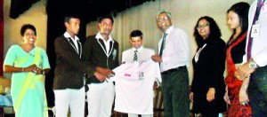 Radley Stephens Country Director CIMA handing over cricket kits to Jayanga Nirmana de Silva captain of STC Matara in the presence of principal W B Piyatissa.