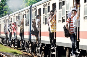 Travel is one dangerous hazard.Workers cling like bats  on overcrowded trains