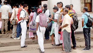 Working people and students are forced to stand in long winding queues to purchase tickets.