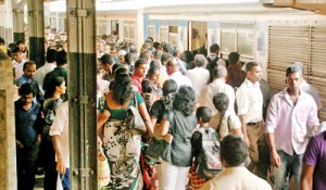 Passengers struggle to board a train at Sri Lanka’s  main station at Fort