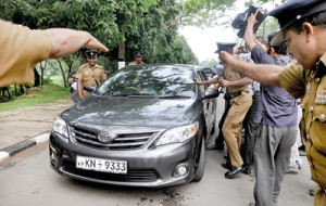 Policemen and cameramen rush towards the vehicle of the CJ as it proceeds towards Parliament on Friday.