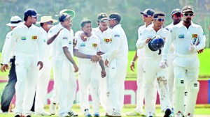 The Lankan players flocking round leg spinner  Rangana Herath after he limited the New Zealand second innings to a mere 118 runs with a match bag of 11 for  108  and made sure of a comfortable  win. (Pic by Amila Gamage)