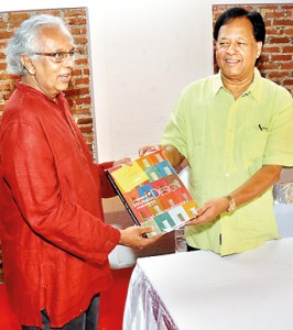 The author hands over the book to chief guest Minister Sarath Amunugama at the launch on Thursday. Pic by Managala Weerasekera