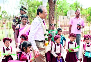 Picture shows Mr Abbas Esufally being escorted by the children of the Silawathei Piyawara Pre-School at the opening.