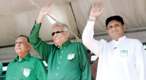 UNP Leader Ranil Wickremesinghe, Deputy Leader Sajith Premadasa and Joseph Michael Perera wave at the delegates after the landmark resolution that gives a six-year term for a party leader was approved at the convention. Pic by Indika Handuwela