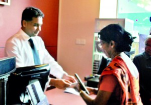 Mr. Rajiv Gunasena, Deputy Managing Director - M. D. Gunasena receiving the first transaction from Mrs. Sujatha Devendra – Vice Principal of Visakha Vidyala