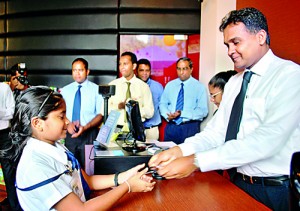Mr. Rajiv Gunasena, Deputy Managing Director - M. D. Gunasena hands over a Loyalty Card to a student of Visakha Vidyala Colombo which was the first school to receive the Loyalty Membership