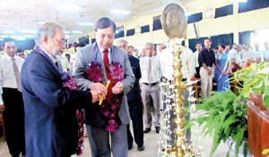 Prof. Sarath Amunugama, Vice Chancellor of the Kelaniya University (left) and Prof. Malik Peiris lighting  the traditional oil lamp at the launch of the 13th Annual Research Symposium