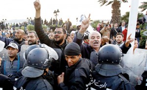 Pro-government Islamists clash near riot police during a demonstration against labour union UGTT that called for a general strike and downfall of the government led by the Islamist Ennahda party at Kasba in Tunis on December 4. Reuters