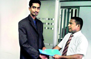 The picture shows Russel Perera, founder of the company, awarding the agency contract to  Mr. Archuthapayan.