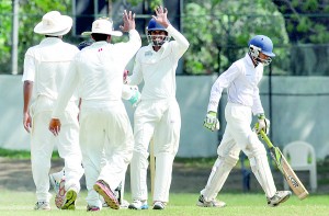 Royal College cricketers celebrate a Dharmaraja wicket at Reid Avenue.