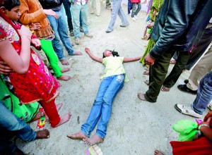 A devotee who is believed to be possessed by evil spirits falls on the ground at Guru Deoji Maharaj temple during a ghost fair at Malajpur village in Betul district in the central Indian state of Madhya Pradesh (REUTERS)