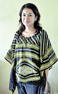 Nishimori wearing  one of the first two tops sewn by the women in the North