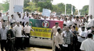 About 3,000 workers stage a protest outside the CMC premises on  Tuesday. Pic by Athula Devapriya