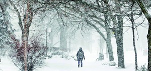 A woman walks through snow during the winter storm (Reuters)