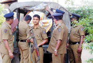 The police bundle into a jeep some of the suspects   arrested. Pix by Indika Handuwala and Reka Tharangani