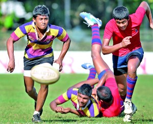 A tussle for the ball..... Two players from Prince of Wales’ and Kingswood take off to win possession.  - Pic by Amila Gamage