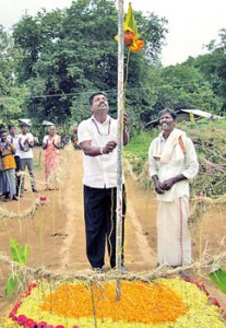 Vavuniya Municipal Council member Lalith Jayasekera hoisting the flag