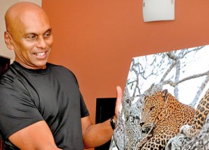 Dr. Harin displays one of his many leopard shots. Pic by Indika Handuwala