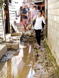 Stepping out from her shanty dwelling