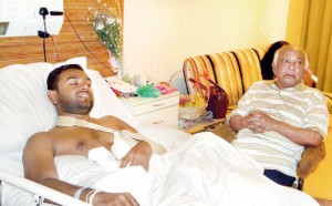 A perfect holiday ruined: Asela Waidyalankara is seen here with his grandfather as he recovers in hospital. Pic by Indika Handuwala