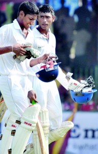 Nalanda batsmen Avishka de Silva and Pramud Hettiwatte walk back to the dressing room after adding an unbroken stand of 167 runs for the sixth wicket against Ananda. 			               - Pic by Amila Gamage