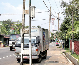 Kiribathgoda-Makola Road: Electricity posts in the middle of the road pose a danger to drivers especially at night time