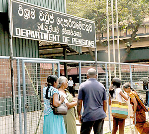 Waiting for redress: Pensioners and family at the Department. Pix by Mangala Weerasekera