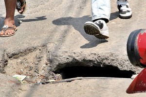 This unprotected manhole is a virtual death-trap which unsuspecting road users could easily  fall victim to