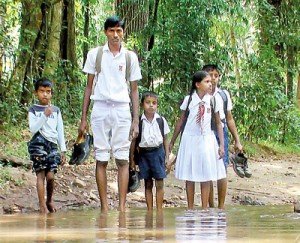 No roads, students must roll up their uniforms and remove footwear to get to school